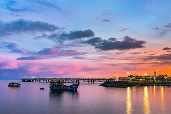 Panama City skyline at dusk seen across the water