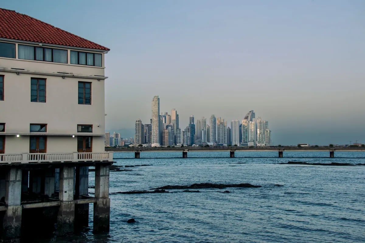 Panama City bay and skyline seen past a red-tiled roof